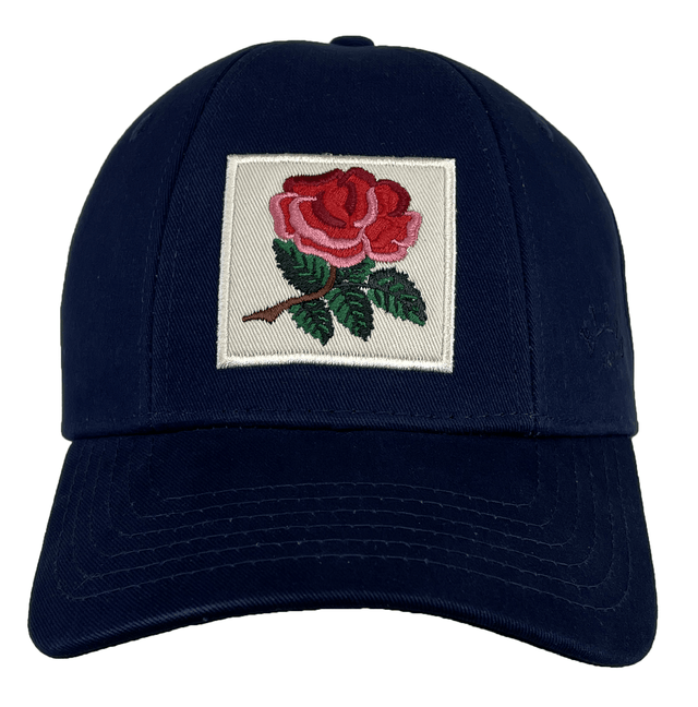 The Ellis Rugby England Rugby 1991 Six Nations Cap by Ellis Rugby features an embroidered red rose with green leaves on a square patch, made from organic cotton in navy.