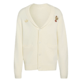 The France FFR 120 Year Cardigan by adidas is a cream rugby cardigan featuring two front pockets, button closure, and embroidered chest patches—an adidas logo and a bear on a unicycle—celebrating French rugby heritage.