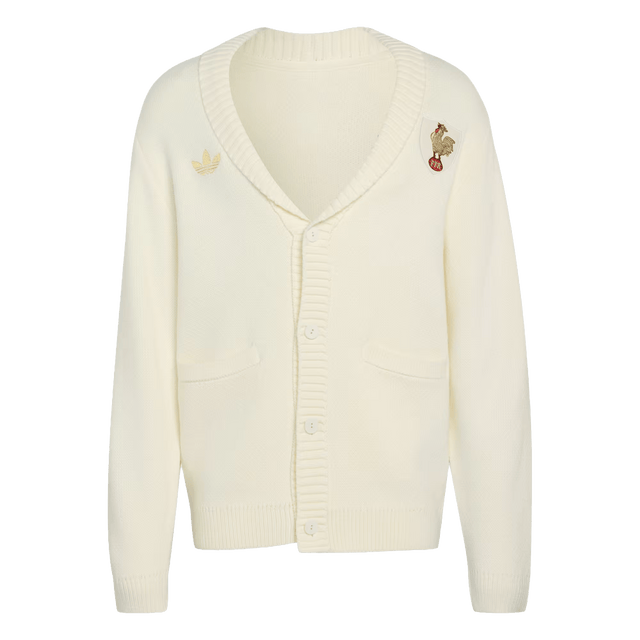 The France FFR 120 Year Cardigan by adidas is a cream rugby cardigan featuring two front pockets, button closure, and embroidered chest patches—an adidas logo and a bear on a unicycle—celebrating French rugby heritage.