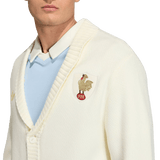 A person wearing the adidas France FFR 120 Year Cardigan, featuring a ribbed collar and rooster crest patch, over a light blue collared shirt—celebrating 120 years of French rugby heritage.