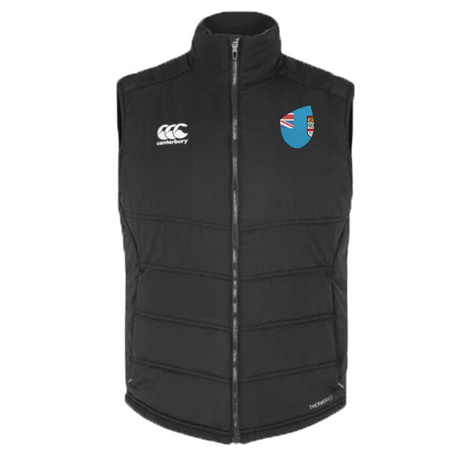 Introducing the Fiji Shield Core Gilet by EMB Canterbury: a sleek black sleeveless vest with a zipper, featuring the Canterbury logo on the left and a crest with the Fiji Shield flag on the right. Perfect for showcasing your unique flair.