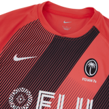 Get into the spirit of the game with the Fiji 7's Replica Away Jersey by Nike. Designed in striking red and black, this jersey proudly displays the iconic Fiji 7s logo and bold "Fiji" text, making it ideal for showing your support both on and off the field.