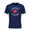 Navy blue XV de France FFR Fan T-Shirt 23/24 by Le Coq Sportif, featuring the text "France Rugby" and "Le Coq Sportif" in white around a red rooster graphic on the front, proudly representing the XV of France.