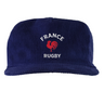 The EMB Weld Nations of Rugby France Corduroy Field Trip Cap is a blue 5-panel hat with "FRANCE RUGBY" and a red rooster logo embroidered on the front, celebrating France’s rugby heritage.