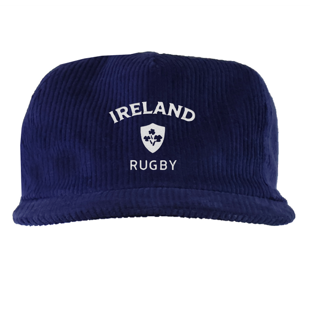The EMB Weld Nations of Rugby Ireland Corduroy Field Trip Cap is a navy blue cap with white "Ireland Rugby" embroidery and a shamrock crest on the front.