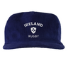 The EMB Weld Nations of Rugby Ireland Corduroy Field Trip Cap is a navy blue cap with white "Ireland Rugby" embroidery and a shamrock crest on the front.