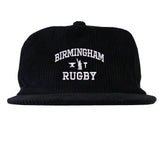 Introducing the EMB Weld Birmingham Rugby Text Logo Corduroy Field Trip Cap: a black corduroy snapback featuring “Birmingham Rugby” embroidered in crisp white lettering on the front. Blending timeless workwear aesthetics with modern comfort, this cap is the perfect choice for fans who love a classic look and easy fit.