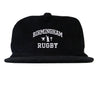 Introducing the EMB Weld Birmingham Rugby Text Logo Corduroy Field Trip Cap: a black corduroy snapback featuring “Birmingham Rugby” embroidered in crisp white lettering on the front. Blending timeless workwear aesthetics with modern comfort, this cap is the perfect choice for fans who love a classic look and easy fit.