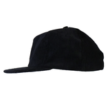 The Weld Corduroy Field Trip Hat, shown in profile on a white background, features a black corduroy design and an adjustable strap.
