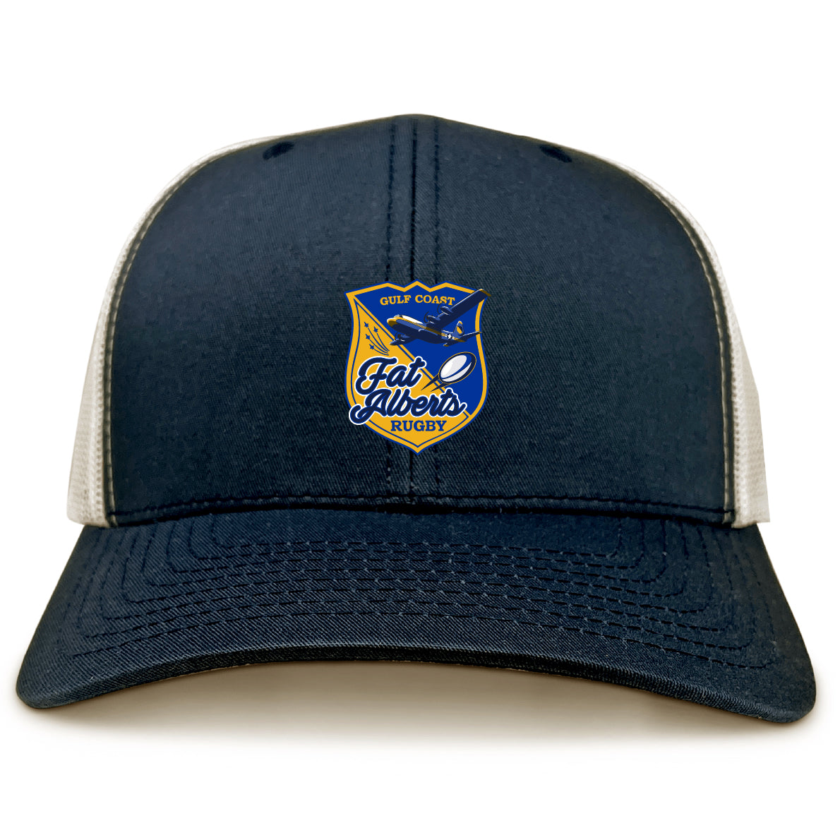 The Gulf Coast Fat Alberts Retro Trucker Cap by EMB S&S Activewear features a navy blue and beige design, an embroidered front logo patch, and a classic snapback closure.
