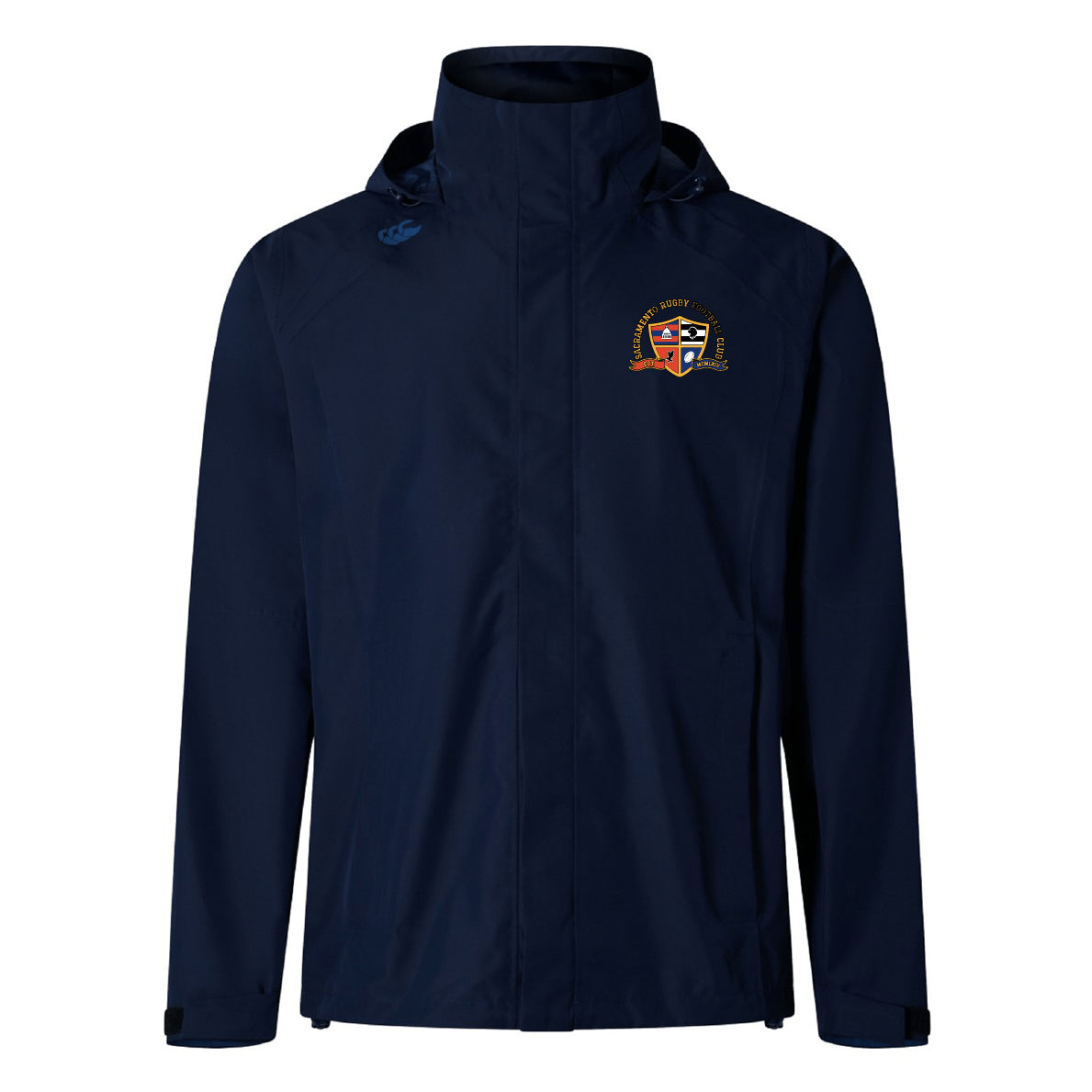 The EMB Canterbury Sacramento Rugby Football Club Elite Storm Jacket features a navy blue design, crest logo on the left chest, and a small blue symbol on the right shoulder. This breathable jacket offers comfort and style for any occasion.
