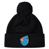 Cheer for Fiji with the Fiji Shield Pom Pom Beanie by EMB Canterbury. This stylish black beanie features a pom-pom and a blue emblem with a flag design, perfect for showcasing your rugby spirit and allegiance to the Fiji Shield.