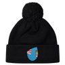 Cheer for Fiji with the Fiji Shield Pom Pom Beanie by EMB Canterbury. This stylish black beanie features a pom-pom and a blue emblem with a flag design, perfect for showcasing your rugby spirit and allegiance to the Fiji Shield.