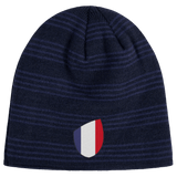 The EMB Canterbury France Shield Beanie is a dark blue, striped beanie featuring the iconic shield emblem in blue, white, and red.