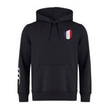The France Shield Club Hoodie by EMB Canterbury is designed from sweatshirt fleece in black, featuring a drawstring hood and brand logo. It has a chest shield with a blue, white, and red design, plus three unique white stripes on the sleeve.