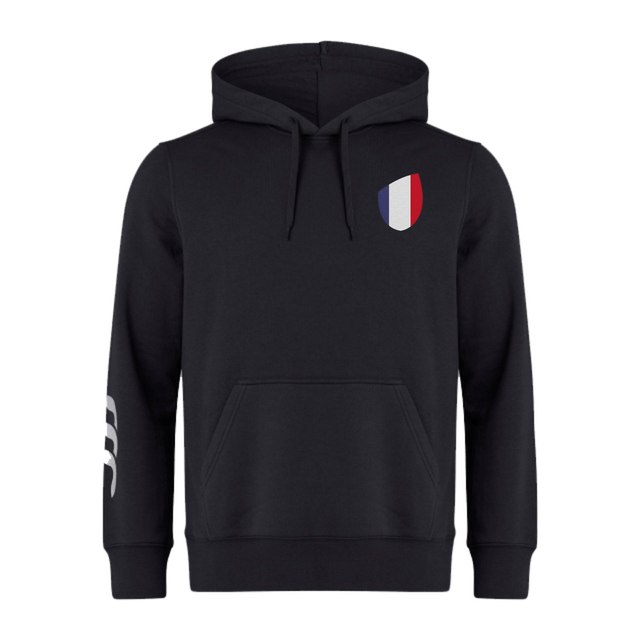 The France Shield Club Hoodie by EMB Canterbury is designed from sweatshirt fleece in black, featuring a drawstring hood and brand logo. It has a chest shield with a blue, white, and red design, plus three unique white stripes on the sleeve.