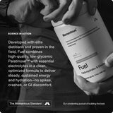 Someone holds a container of Momentous Fuel by Momentous, a carb electrolyte formula for sustained energy, with text highlighting its benefits and clean ingredients in the background.