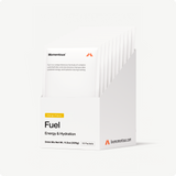 A white box labeled Momentous Fuel 10-Travel Packs contains ten mango-flavored carb-electrolyte drink mix packets for sustained energy during endurance exercise. The brand Momentous and website info appear on the box.