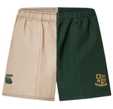 The Exiles Rugby Fundamental Harlequin Drill Short by EMB Canterbury features beige and dark green vertical panels, "CCC" and crest with "EXILES RFC" logos—ideal for rugby training or everyday comfort.