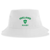The Nations of Rugby Ireland Rugby Sustainable Bucket Hat by EMB S&S Activewear is a white bucket hat crafted from recycled polyester, featuring "Ireland Rugby" and a green shamrock emblem on the front for an eco-friendly and stylish choice.