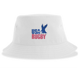 The USA Rugby Throwback Sustainable Bucket Hat by EMB S&S Activewear features a white design with the iconic blue-and-red logo and an eagle graphic soaring above the word "Rugby," combining classic throwback style with sustainable materials.