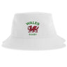 The Nations of Rugby Wales Rugby Sustainable Bucket Hat by EMB S&S Activewear features a white design with the red Welsh dragon and green "WALES RUGBY" text on the front, crafted from recycled polyester for an eco-friendly choice.