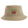 The Nations of Rugby Wales Rugby Sustainable Bucket Hat by EMB S&S Activewear is made from recycled polyester for a more eco-friendly option. This beige bucket hat features green "WALES RUGBY" text and a red dragon emblem printed on the front.