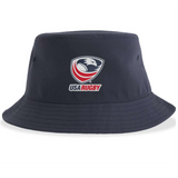 Introducing the USA Rugby Crest Sustainable Bucket Hat by EMB S&S Activewear—a navy blue bucket hat made from recycled polyester for eco-friendly style and comfort. The front showcases the official USA Rugby logo, featuring a stylized eagle head with red text, prominently centered.