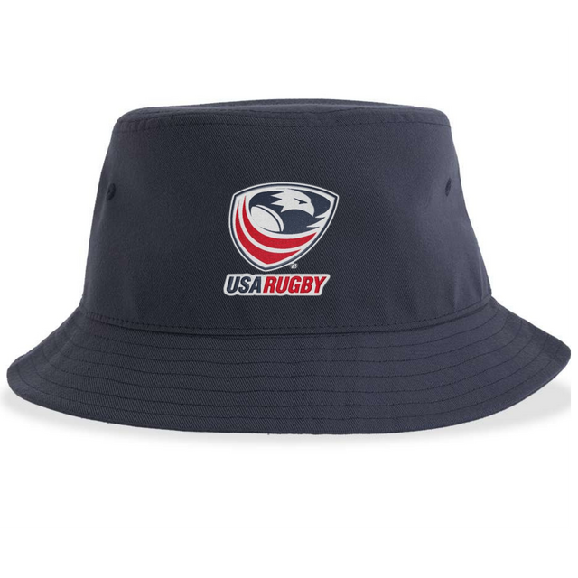 Introducing the USA Rugby Crest Sustainable Bucket Hat by EMB S&S Activewear—a navy blue bucket hat made from recycled polyester for eco-friendly style and comfort. The front showcases the official USA Rugby logo, featuring a stylized eagle head with red text, prominently centered.