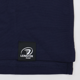 A close-up of the hem of the Leinster 24/25 Club Essential Polo by Castore, featuring a sewn-on label with the Leinster Rugby logo and text.