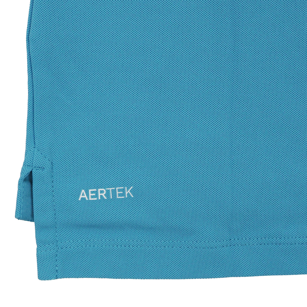 Close-up of the hem of a blue Leinster 24/25 Club Essential Polo by Castore, featuring the brand name "CASTORE" printed in white letters near the bottom edge.