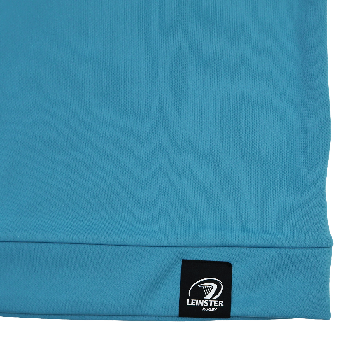 Close-up of a blue Castore Leinster 24/25 Club Classic 1/4 Zip pullover with a black "Leinster Rugby" tag and logo, part of the athletic mid-layer range.