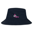 The Girls Rugby Crusher Bucket Cap by EMB S&S Activewear is a black cotton twill hat featuring a white and pink "girls rugby" logo embroidered on the front, combining style with sun protection.