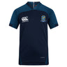 The Gretna United Rugby Vapodri Evader Jersey by Canterbury, from EMB Canterbury, is a navy short-sleeve V-neck shirt with dark blue shoulder panels, Goldington Academy logos on the chest, and moisture-wicking technology for comfort.