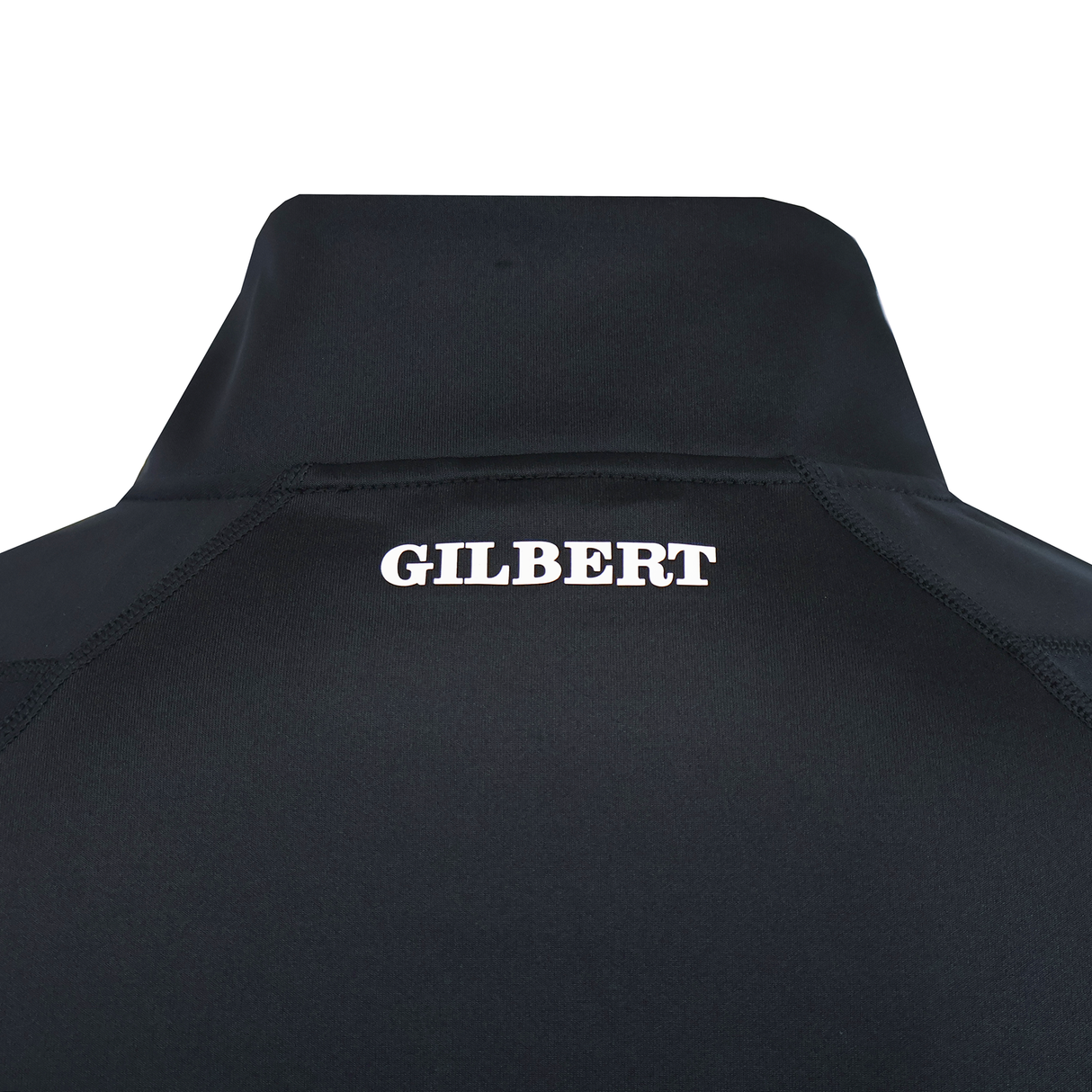 Close-up of the back of the black Gilbert GTS 1/4 Zip Poly Pullover, with "GILBERT" printed in white capital letters near the collar.