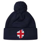 The EMB Canterbury Great Britain Shield Pom Pom Beanie is a dark blue knit hat featuring a pom-pom and a shield patch displaying the Union Jack, capturing the spirit of Great Britain.