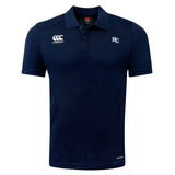 The Holy Cross Club Dry Polo by EMB Canterbury features navy blue fabric, short sleeves, collar, button placket, "Canterbury" logo at right chest, "HC" initials at left chest, and Vapodri Technology for breathability.
