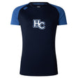 The Holy Cross Women's Elite Training Tee by WRS Canterbury features navy Vapodri fabric, short royal blue sleeves, and bold white "HC" letters outlined in blue on the chest for breathable comfort during workouts.