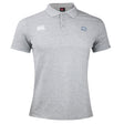 The Holy Cross Waimak Polo by Canterbury is a light grey short-sleeve rugby polo with a collar, featuring the EMB Canterbury logo on the right chest and an "HC" emblem on the left, inspired by the classic CCC Waimak Rugby Polo.
