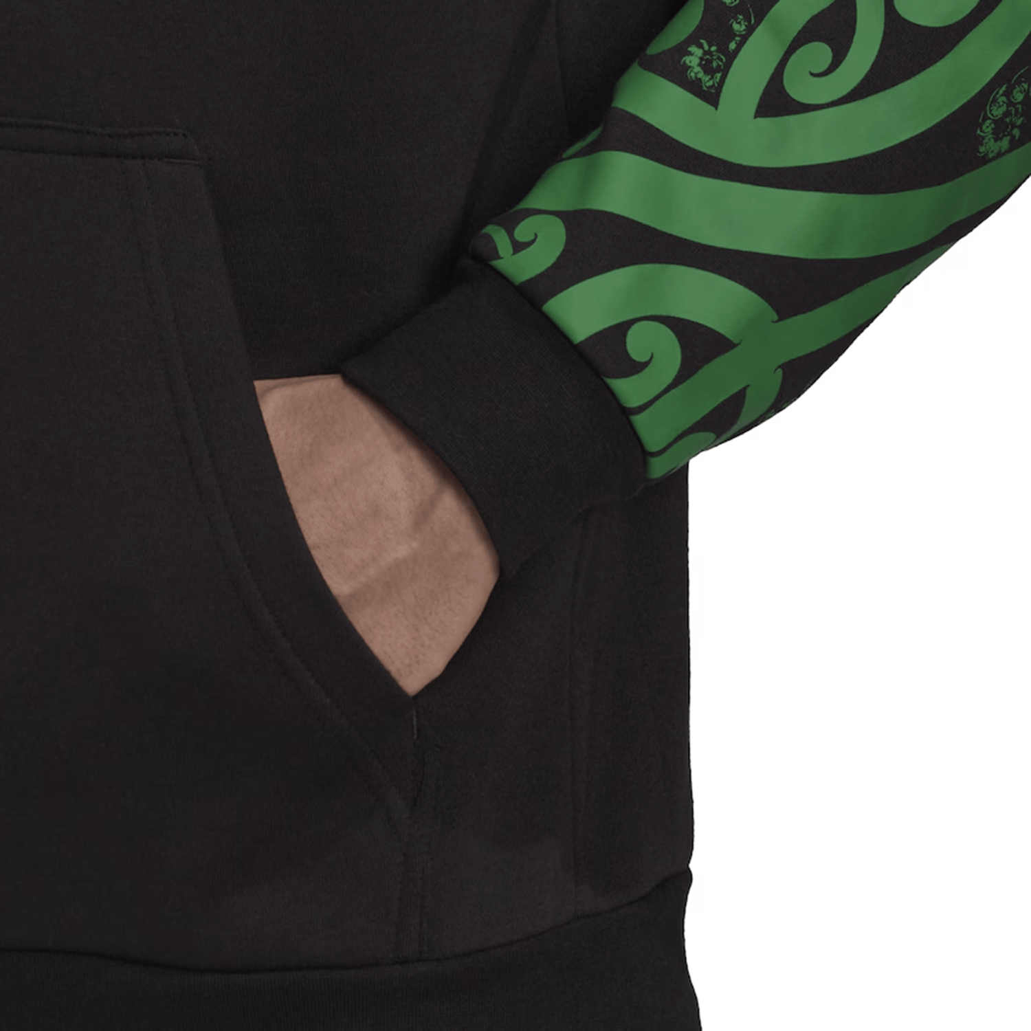 A person wearing the Maori All Blacks Performance Hoodie by adidas, featuring black fabric with green swirl patterns on the sleeve, has their hand in the front pocket.