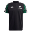 Maori All Blacks Performance Polo by adidas showcases a striking black design with the classic white Adidas logo and "Māori All Blacks" text, accompanied by a fern emblem on the front. The shoulders are enhanced with a green Māori pattern, while three white stripes adorn the sleeves. It also features moisture-wicking AEROREADY technology for added comfort.