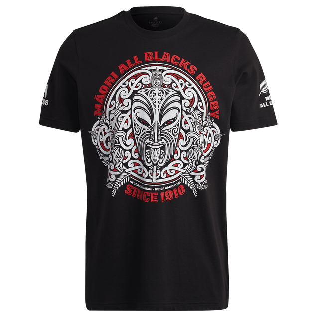The Maori All Blacks Graphic Tee by adidas features a bold Māori-inspired front design with "Māori All Blacks Rugby Since 1910" in red and white, plus All Blacks logos on both sleeves—a standout tribute to tradition from Adidas.