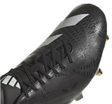 Close-up of an adidas adizero RS15 Pro SG 23 in Core Black/White/Carbon with black laces and white striped accents, featuring a textured surface and gold-tipped studs.