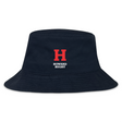 The Howard University Crusher Bucket Cap by EMB S&S Activewear is a navy cotton twill hat with a bold red "H" and "Howard Rugby" in white on the front, combining style and sun protection.