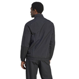 A man stands with his back turned, wearing an All Blacks Presentation Jacket by adidas, featuring a dark tracksuit style inspired by rugby fashion.