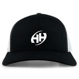 The Clarksville Headhunters Retro Trucker Cap by EMB S&S Activewear features a black and white design, curved brim, white "HH" embroidery on the front, and a classic snapback closure.