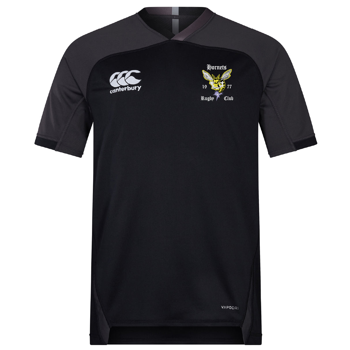 The EMB Canterbury Hornets Rugby Club Vapodri Evader Jersey is a black short-sleeved top with moisture-wicking tech, featuring the Canterbury logo and a yellow hornet crest reading “Hornets Rugby Club 1977” on the chest.
