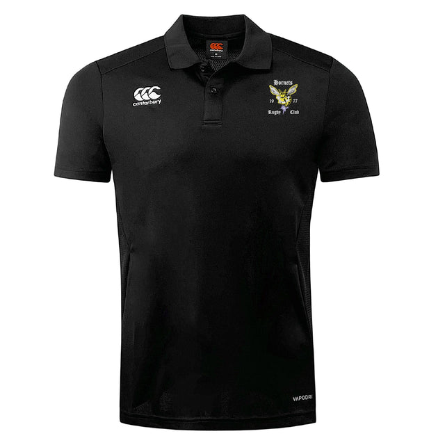The Hornets Rugby Club Club Dry Polo by EMB Canterbury is a black, short-sleeve collared shirt with the Canterbury logo and badges, "Hornets Rugby Club" on the chest, and features breathable Vapodri Technology for comfort.