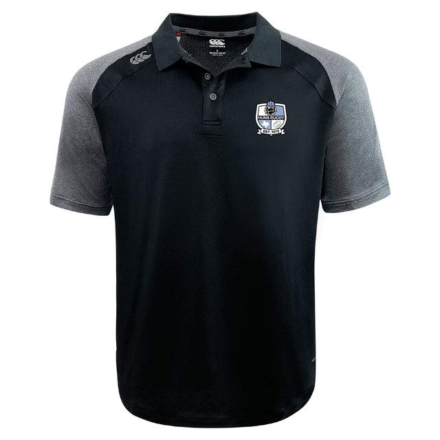 The Austin Huns Rugby Elite Polo by EMB Canterbury features Vapodri fabric, is lightweight and durable, with black and gray design, a collar, button placket, and embroidered crest logo on the left chest.
