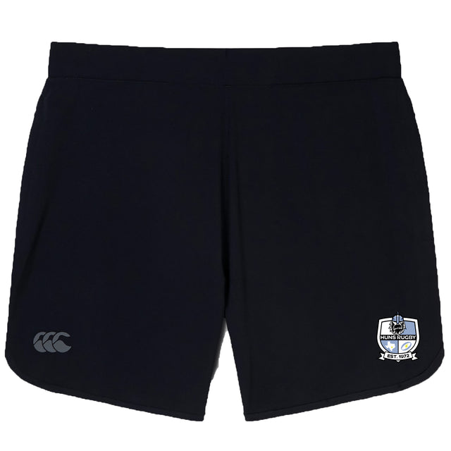 The Austin Huns Rugby Women's Elite Woven Short by Canterbury features a black design, EMB Canterbury logo on the left leg, Austin Huns crest on the right, and zippered pockets for secure storage during training.